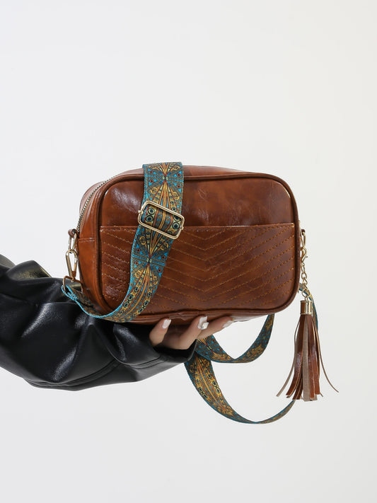 Bolso bandolera con correa de piel estampada