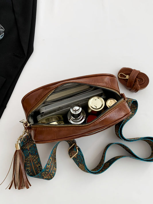 Bolso bandolera con correa de piel estampada